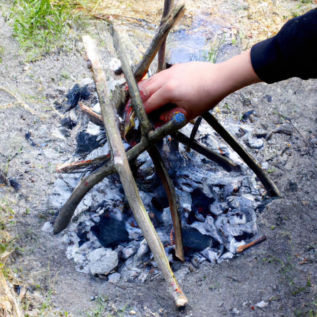 Person building a campfire